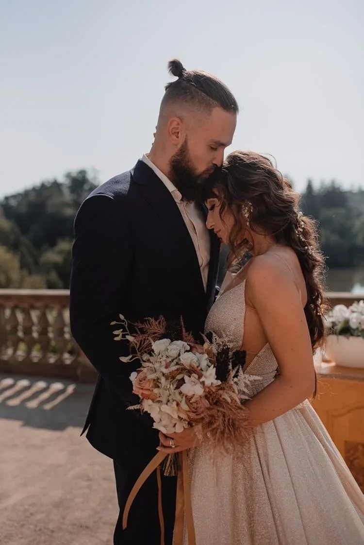 Novomanželé na terase s boho kyticí